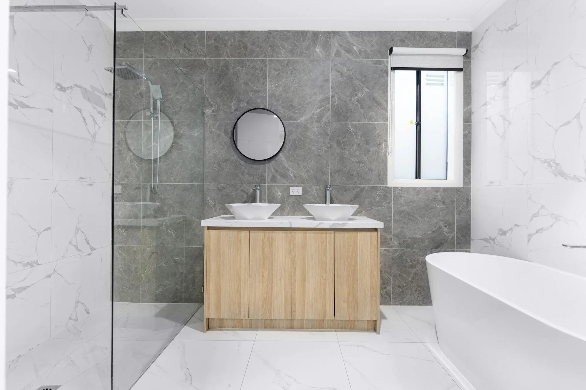 Modern bathroom fit-out with walk-in shower and freestanding bath